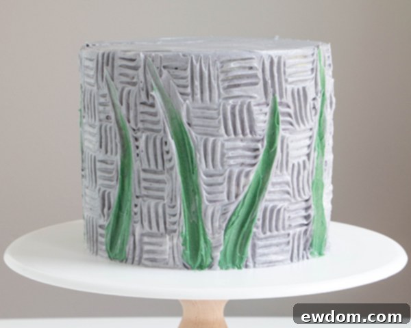 Completed array of green buttercream stems around the cake, ready for flowers