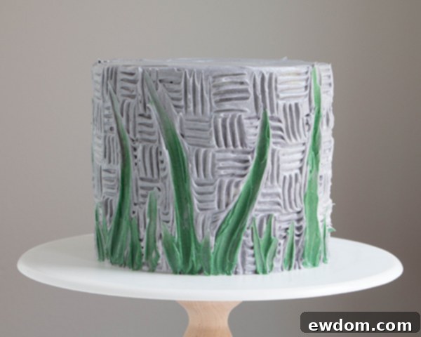 Full view of the cake with textured background, green stems, and grass details