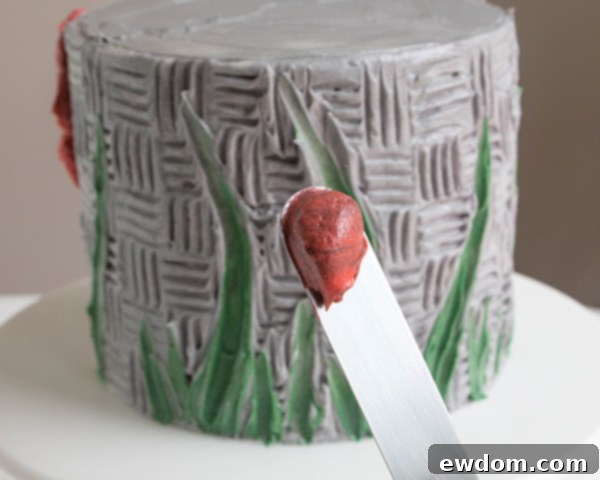 Preparing multi-colored buttercream for flower petals, showing the streaky mixing technique