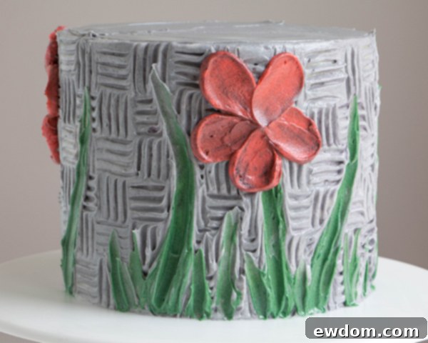 Completed buttercream palette knife flower on cake, demonstrating the circular petal arrangement