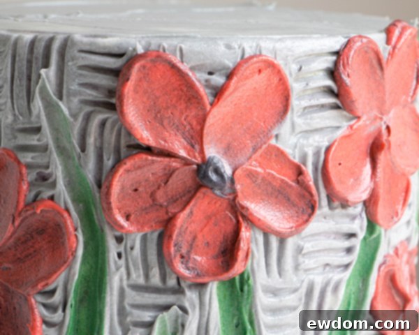 Detailed view of a buttercream flower with a newly added black center