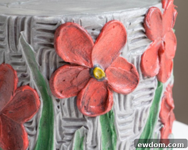 Close-up of a finished buttercream palette knife painted flower with black and yellow center