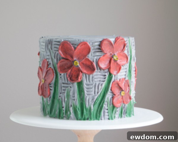 Final triumphant shot of the completed buttercream palette knife painted cake with vibrant flowers