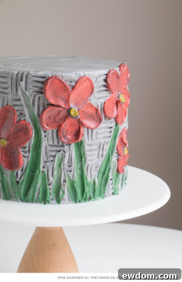 Detailed view of a buttercream palette knife painted cake with textured flowers and leaves by Erin Gardner