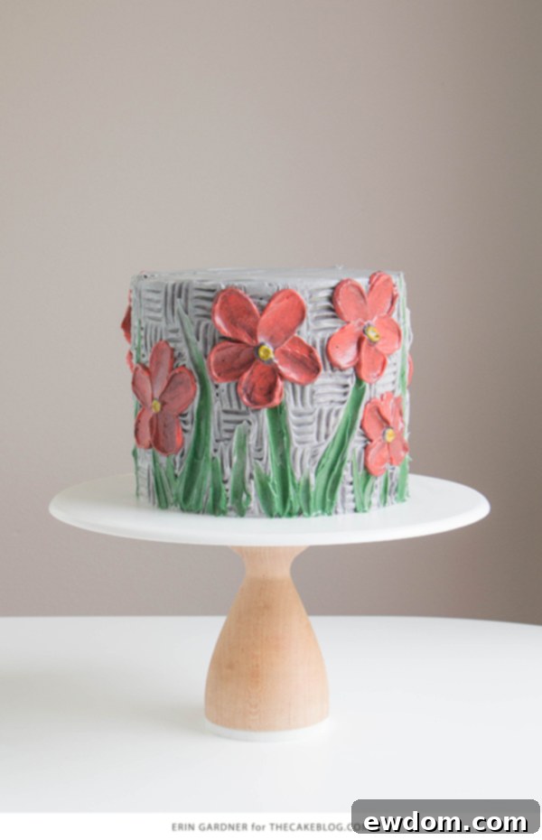 Close-up of vibrant buttercream palette knife painted flowers on a cake, showcasing texture and depth