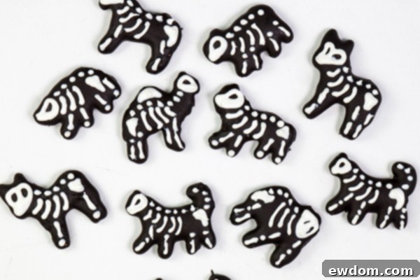 A collection of completed white chocolate animal cracker skeletons, detailed and ready for placement on the Halloween carousel cake | by Erin Gardner for TheCakeBlog.com