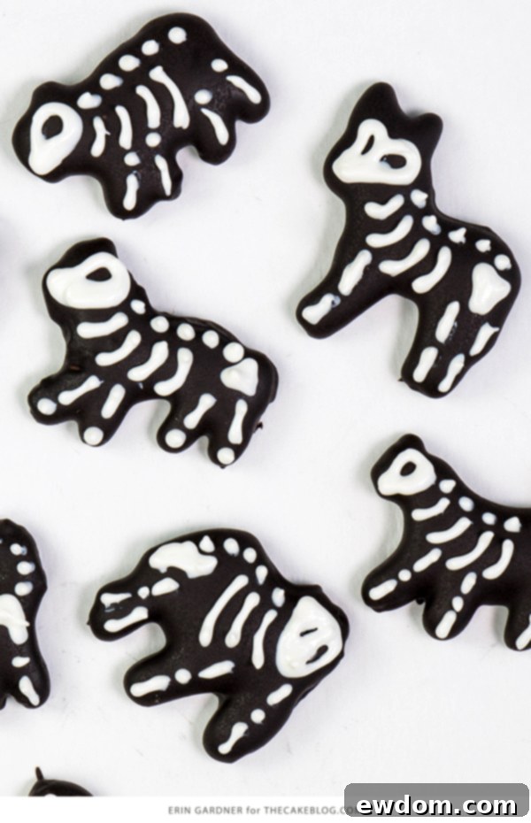 Detailed shot of the carousel cake's base, adorned with colorful Halloween sprinkles and topped with a black chocolate ganache drip, hinting at the delightful details to come | by Erin Gardner for TheCakeBlog.com