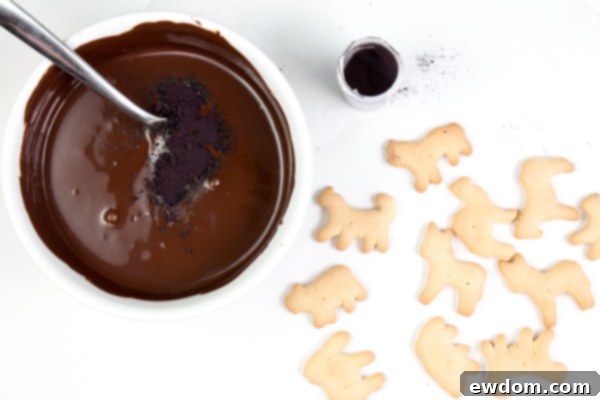 Melting dark chocolate in a bowl, a crucial first step for creating the spooky animal cracker skeletons for the carousel cake | by Erin Gardner for TheCakeBlog.com