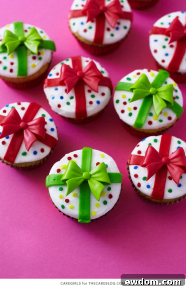 A beautifully arranged selection of Christmas Present Cupcakes, showcasing different ribbon and bow color combinations, perfect for holiday celebrations.