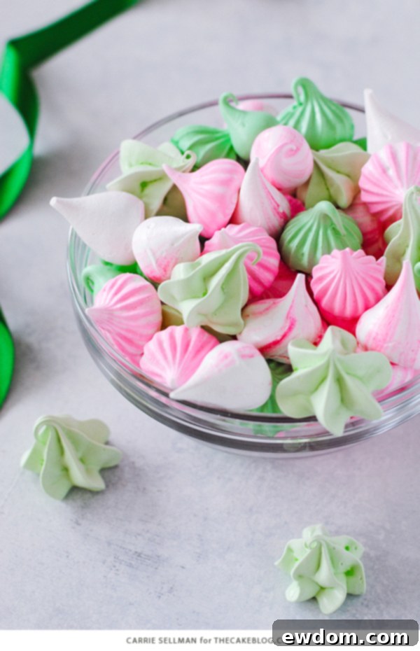 Colorful Meringue Kisses delicately piped and arranged, showcasing their vibrant hues and airy texture.