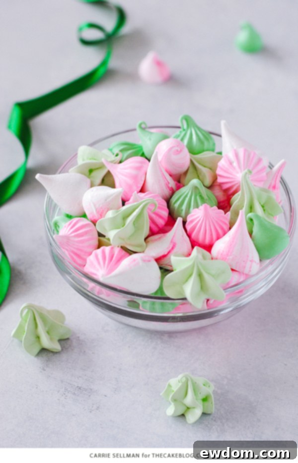 Sweet Whispers 6 Meringue Kisses - Melt-in-your-mouth mini meringue cookies that are light as air, naturally low calorie, dairy free, gluten free, and soy free. Meringue kisses arranged on a rustic wooden surface with decorative elements. | by Carrie Sellman for TheCakeBlog.com