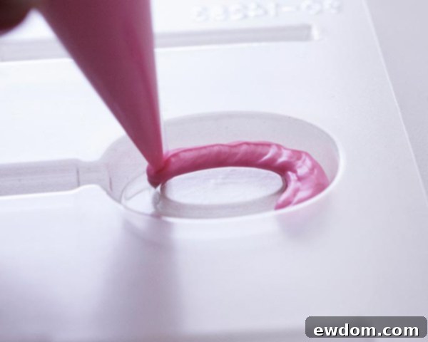 XOXO Valentine's Day Cake - how to make a pink ombre striped cake decorated with chocolate lips, hearts and an XOXO topper | by Cakegirls for TheCakeBlog.com