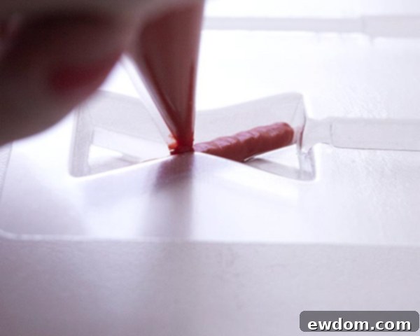 XOXO Valentine's Day Cake - how to make a pink ombre striped cake decorated with chocolate lips, hearts and an XOXO topper | by Cakegirls for TheCakeBlog.com