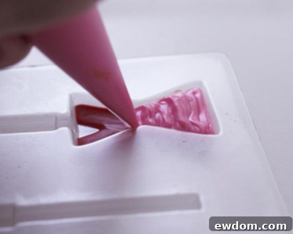 XOXO Valentine's Day Cake - how to make a pink ombre striped cake decorated with chocolate lips, hearts and an XOXO topper | by Cakegirls for TheCakeBlog.com