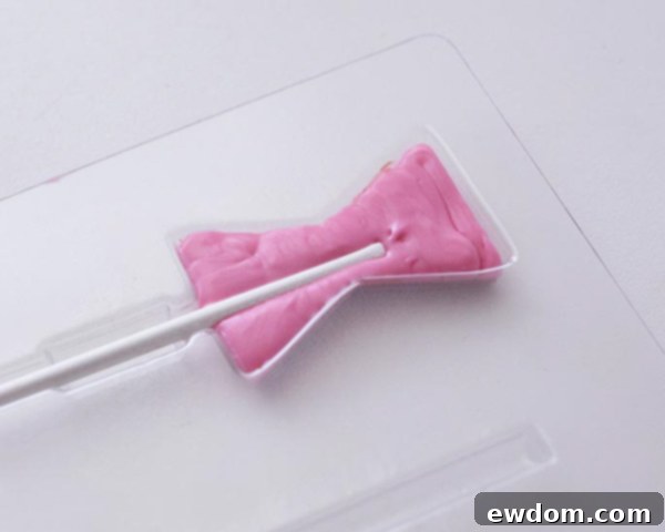 XOXO Valentine's Day Cake - how to make a pink ombre striped cake decorated with chocolate lips, hearts and an XOXO topper | by Cakegirls for TheCakeBlog.com