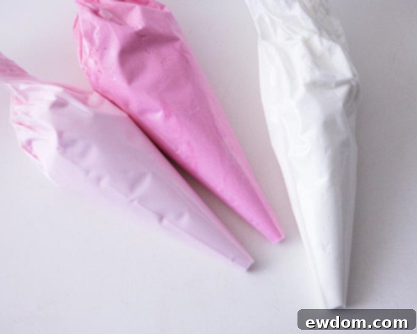 XOXO Valentine's Day Cake - how to make a pink ombre striped cake decorated with chocolate lips, hearts and an XOXO topper | by Cakegirls for TheCakeBlog.com