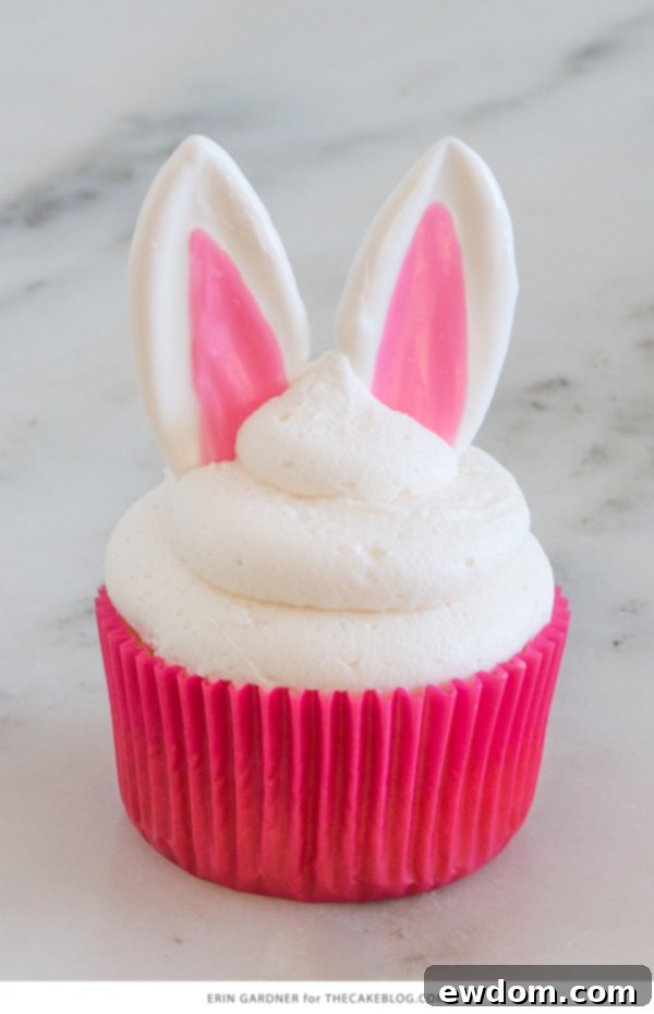 Side view of Easter Bunny Cupcakes with chocolate ears and tiny buttercream floral headbands, showcasing their charming details.