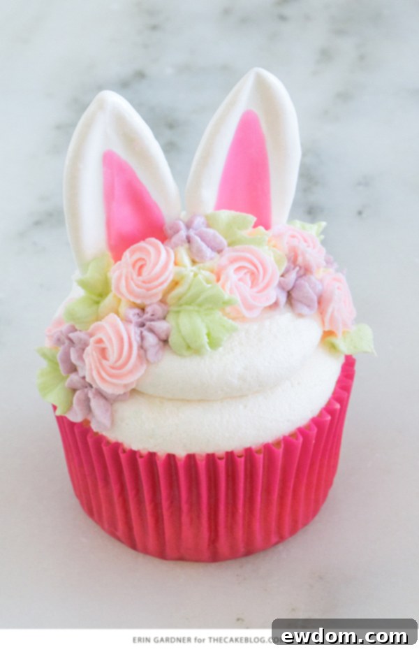 Overhead view of several Easter Bunny Cupcakes, each adorned with chocolate ears and a colorful buttercream flower crown.