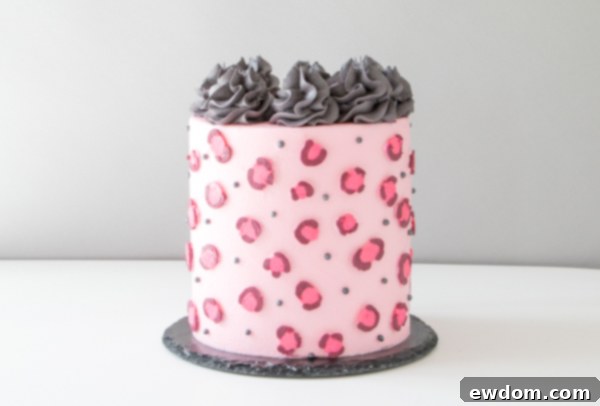 Chic Leopard Buttercream 15 Piping dark gray buttercream swirls onto the top of the pink leopard cake