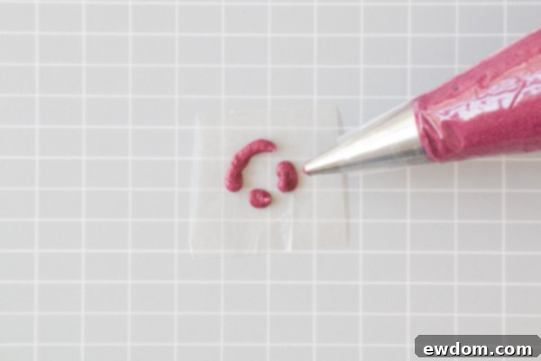 Chic Leopard Buttercream 7 Piping burgundy buttercream outlines onto waxed paper for leopard spots