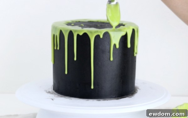 Sorceress's Potion Cake 14 Dripping vibrant green ganache over the edges of the black buttercream cake