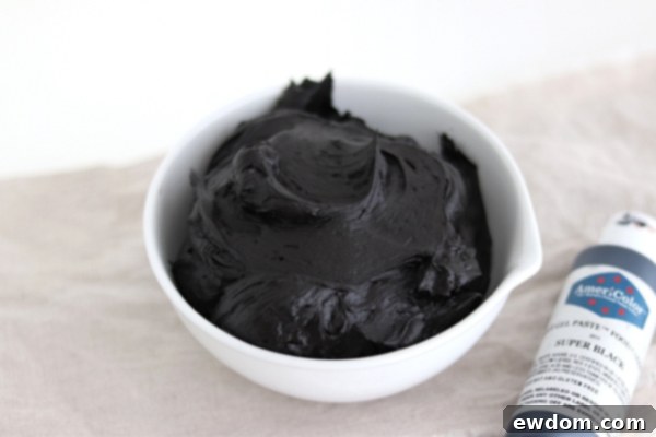 Sorceress's Potion Cake 7 Image demonstrating how to color chocolate buttercream black for the cauldron cake