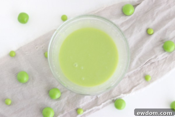 Sorceress's Potion Cake 10 Whisking melted white chocolate and cream to create the ganache for the Halloween cake