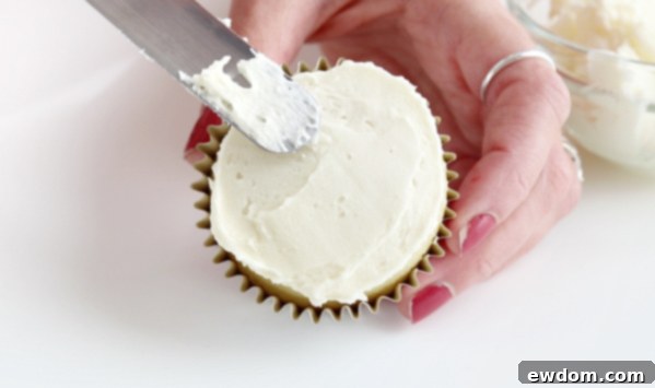Festive Wreath Cupcakes 11 Cupcake with a thin, even layer of uncolored buttercream frosting