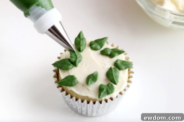 Festive Wreath Cupcakes 12 Piping initial layer of green leaves for the berry wreath cupcake