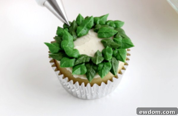 Festive Wreath Cupcakes 13 Filling in gaps with a second shade of green leaves for a two-toned wreath