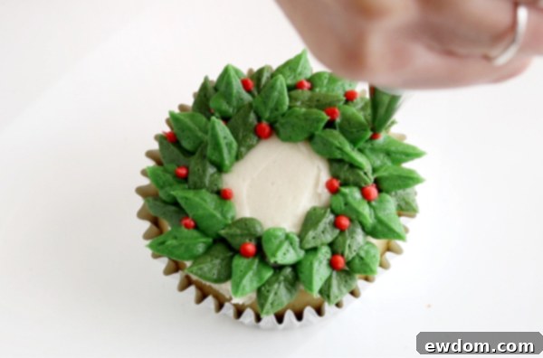 Festive Wreath Cupcakes 14 Adding red buttercream berries to the finished green wreath