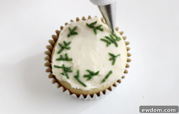 Festive Wreath Cupcakes 16 Piping initial layer of pine sprigs for the wreath design