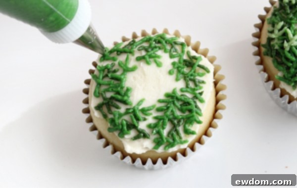 Festive Wreath Cupcakes 17 Layering second shade of green pine sprigs on the cupcake