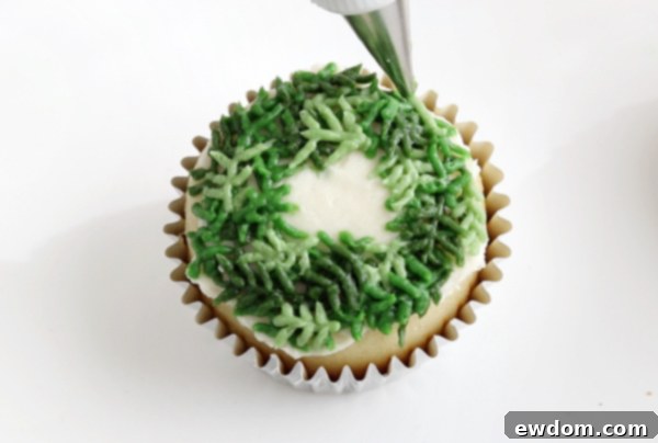 Festive Wreath Cupcakes 18 Adding the third shade of green pine sprigs to create a full wreath