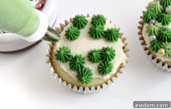 Festive Wreath Cupcakes 20 Piping initial layer of green drop stars for the sprinkled wreath