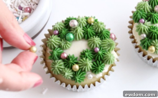 Festive Wreath Cupcakes 22 Adding festive sprinkles to the buttercream wreath for an ornament effect