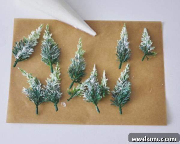 Enchanted Snowflake Cake 14 Novelty pine trees being prepared for placement on the cake