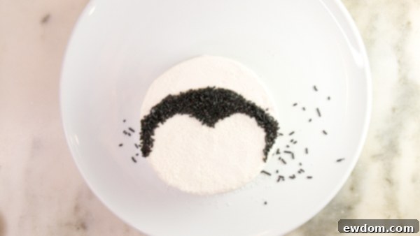 Tuxedo Treat 10 Applying black sprinkles for penguin body