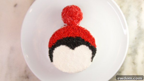 Tuxedo Treat 13 Penguin cake with cupcake hat attached