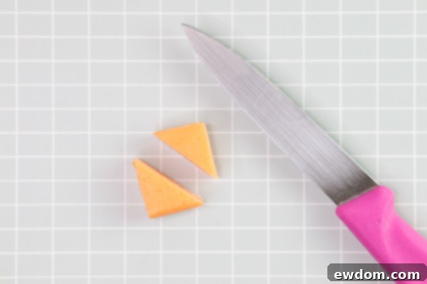 Tuxedo Treat 14 Adding beak and cheeks to penguin cake