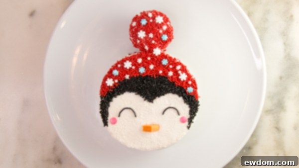 Tuxedo Treat 15 Piping eyes and decorating hat on penguin cake