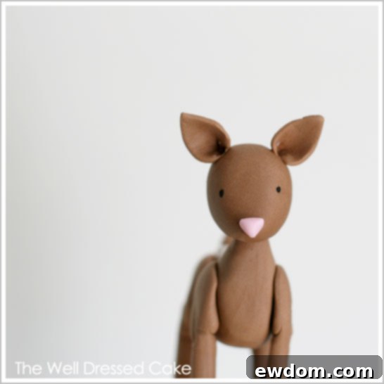 Close-up of the adorable fondant deer topper on the Woodland Baby Shower Cake