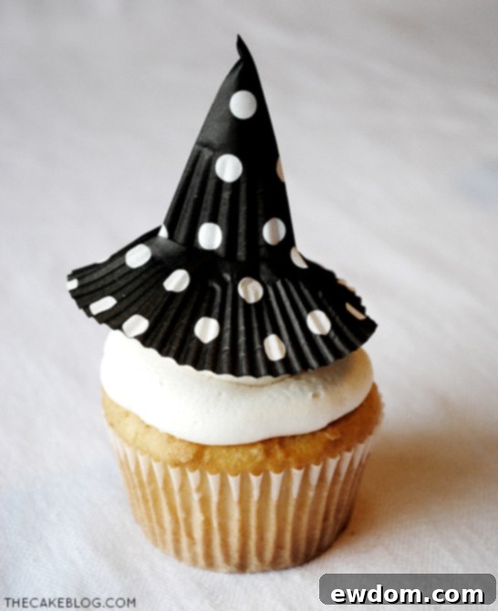 Detailed view of a handmade cupcake liner witch hat on a Halloween cupcake