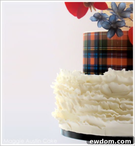 Close-up of Maggie Austin's Ruffles and Plaid Christmas Cake, highlighting the vibrant Scottish tartan pattern