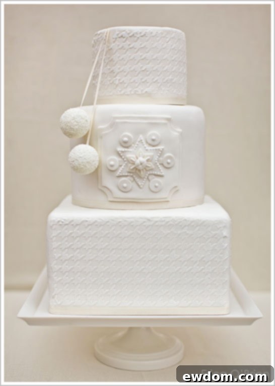 Snowy White Winter Wedding Cake featuring elegant houndstooth pattern and pom-poms by Erica O'Brien